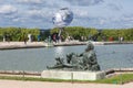 Visitors in garden Palace Versailles with statue and pond at Paris, France Royalty Free Stock Photo