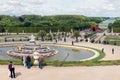 Visitors in garden Palace Versailles with statue and pond at Paris, France Royalty Free Stock Photo