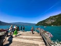 visitors of lake annecy on boardwalk talloires Royalty Free Stock Photo