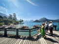 visitors of lake annecy on boardwalk talloires Royalty Free Stock Photo