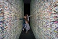 Visitors looking at installation made of books and mirrors: Passage at the City Gallery of Bratislava, Slovakia