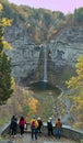 Visitors looking at waterfall, Taughannock Falls, tourist destination in Finger Lakes, New York. Travel, tourism in autumn.