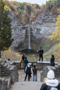 Visitors looking at waterfall, Taughannock Falls, tourist destination in Finger Lakes, New York. Travel, tourism in autumn.