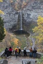 Visitors looking at waterfall, Taughannock Falls, tourist destination in Finger Lakes, New York. Travel, tourism in autumn.