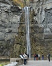 Visitors looking at waterfall, Taughannock Falls, tourist destination in Finger Lakes, New York. Travel, tourism in autumn.