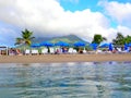 Visitors On Lounge Chairs Under Umbrellas at Pinney\'s Beach, Nevis