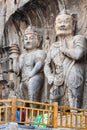 Visitors near Buddhist sculptures in grotto