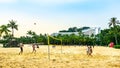 Visitors playing volleyball at Siloso Beach, Sentosa Island, Singapore. Royalty Free Stock Photo
