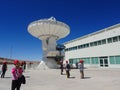 Visitors at a radiotelescope, large antenna at Alma Observatory in San Pedro de Atacama, Chile