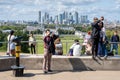 Visitors at the Royal Observatory in Greenwich with a view of Greenwich Park and Canary Wharf Royalty Free Stock Photo