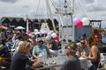 Visitors sit by the harbour to sample oysters at the Whitstable Oyster Festival Royalty Free Stock Photo