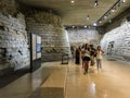 Visitors study a portion of the medieval Louvre as preserved in the modern museum, Paris, France