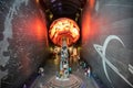 Visitors taking an escalator to the Earth Hall through a globe in the Natural History Museum, London