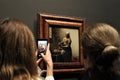 Visitors taking photos and admiring the painting at Rijksmuseum.