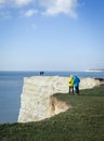 Visitors taking photos near the cliff edge at England Seven Sisters in a sunny day