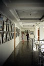 Visitors to the exhibition hall. Long hall corridor with paintings at the exhibition.