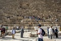 Visitors to Giza in Cairo in Egypt climb over the Pyramid of Khufu. Royalty Free Stock Photo