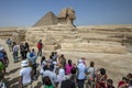 Visitors to Giza in Cairo in Egypt view the Pyramid of Khufu and the Sphinx.