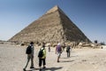 Visitors to Giza gather around the base of the Pyramid of Khafre in Cairo, Egypt.