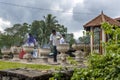 Visitors to the Sacred Temple of the Tooth Relic at Kandy in Sri Lanka light incense sticks in pots.