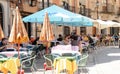 Visitors and tourists eating and drinking on a sunny day on the terraces of the city of Zamora in Spain.