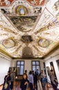 Visitors view ceiling in room in Uffizi Gallery