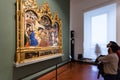 Visitors view painting in room of Uffizi Gallery Royalty Free Stock Photo