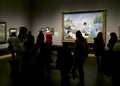 Visitors viewing paintings in the National Gallery, london