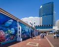 Visitors walk along the promenade at Darling Harbour