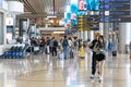 Visitors walk around Departure Hall in Changi Airport Terminal 4, Singapore Royalty Free Stock Photo