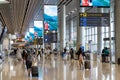 Visitors walk around Departure Hall in Changi Airport Terminal 4, Singapore Royalty Free Stock Photo