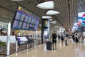 Visitors walk around Departure Hall in Changi Airport Terminal 4, Singapore Royalty Free Stock Photo