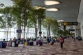 Visitors walk around Departure Hall in Changi Airport Terminal 4, Singapore Royalty Free Stock Photo