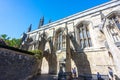 Visitors walk through Winchester Cathedral buttresses