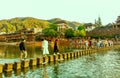 Visitors Walking On The Stepping Stones Bridge Over Tuojiang River In Fenghuang Ancient Town, China. Royalty Free Stock Photo