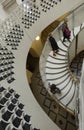 Visitors walking up a spiral staircase