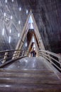 Visitors walking on a wooden bridge in salt mine T