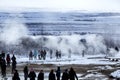 Visitors watching the eruption of a geyser in Iceland