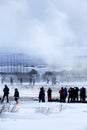 Visitors watching the eruption of a geyser in Iceland