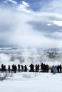 Visitors watching the eruption of a geyser in Iceland