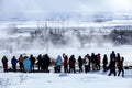 Visitors watching the eruption of a geyser in Iceland