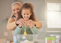 Visits to grandma means freshly baked cookies. a woman baking with her granddaughter at home. Royalty Free Stock Photo