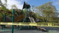 Vista, CA / USA - March 25, 2020: Bi-lingual caution tape ropes of a California playground closed down due to Covid-19