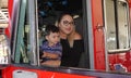 Parents take pictures of kids exploring firetruck