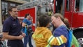 Vista, CA / USA - October 13, 2018: People interact with firefighters and explore trucks during fire prevention month open house.