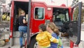 Vista, CA / USA - October 13, 2018: People interact with firefighters and explore trucks during fire prevention month open house.