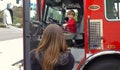 Vista, CA / USA - October 13, 2018: People interact with firefighters and explore trucks during fire prevention month open house.