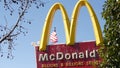 VISTA, CALIFORNIA USA - 16 FEB 2020 McDonalds logo sign and American flag. Yellow letter M icon and Stars and Stripes. Golden