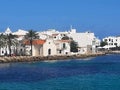 Photograph of a coastal village on the island of Menorca taken from a boat