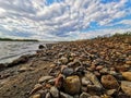 Vistula river on the outskirts of the city, wonderful spring scenery of Masovian landscape, colorful stones on the river bank